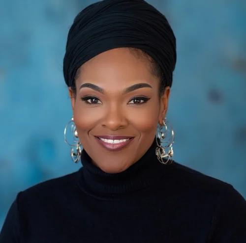 Auntie NY (Naaila Moumaris), Licensed Clinical Social Worker and founder, smiling warmly in professional attire